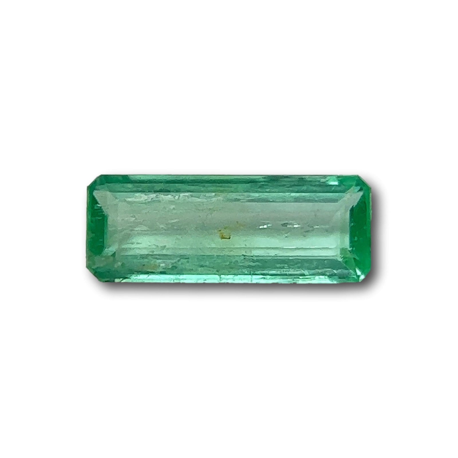 0.45ct long emerald-cut Muzo Colombian emerald gemstone with a vibrant green hue and step-cut facets.