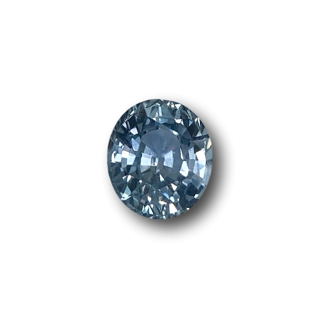 0.97ct oval brilliant cut Montana sapphire with a faceted blue surface against a white background.