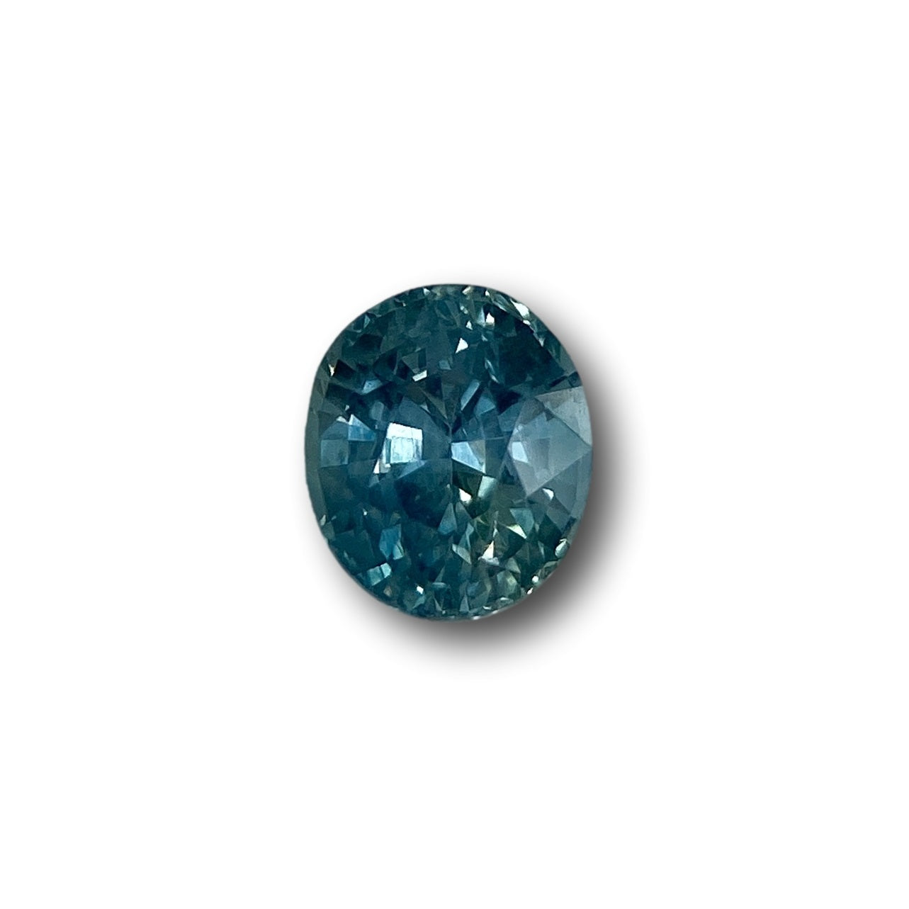 0.97ct oval brilliant cut blue Montana sapphire gemstone with faceted surface.