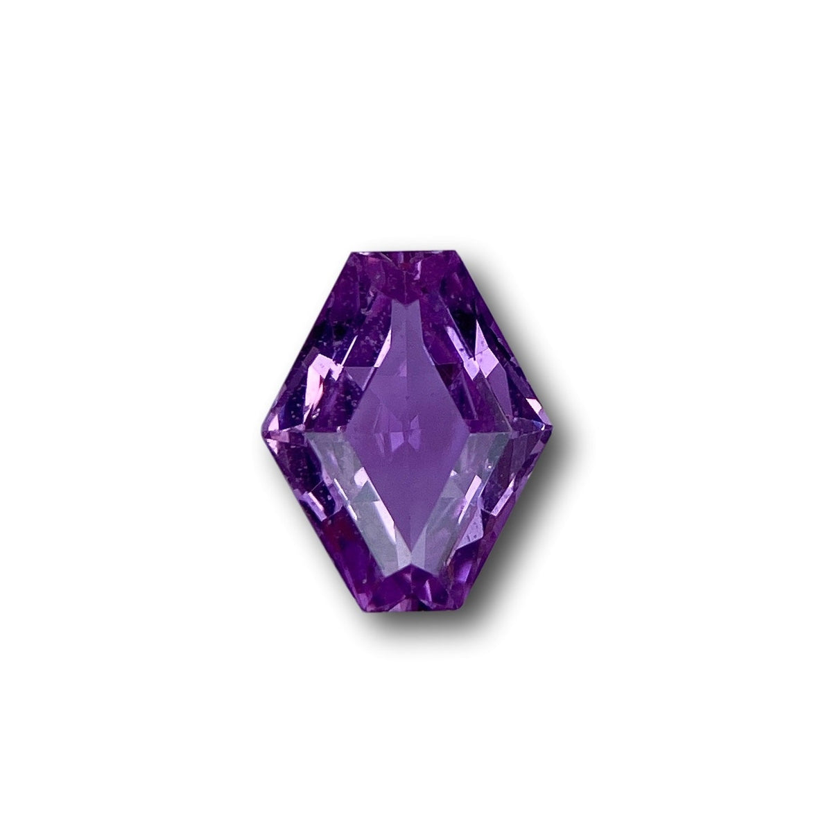 1.00ct brilliant cut violet sapphire in a unique lozenge shape, measuring 7.60 x 6.10 mm against a white background.