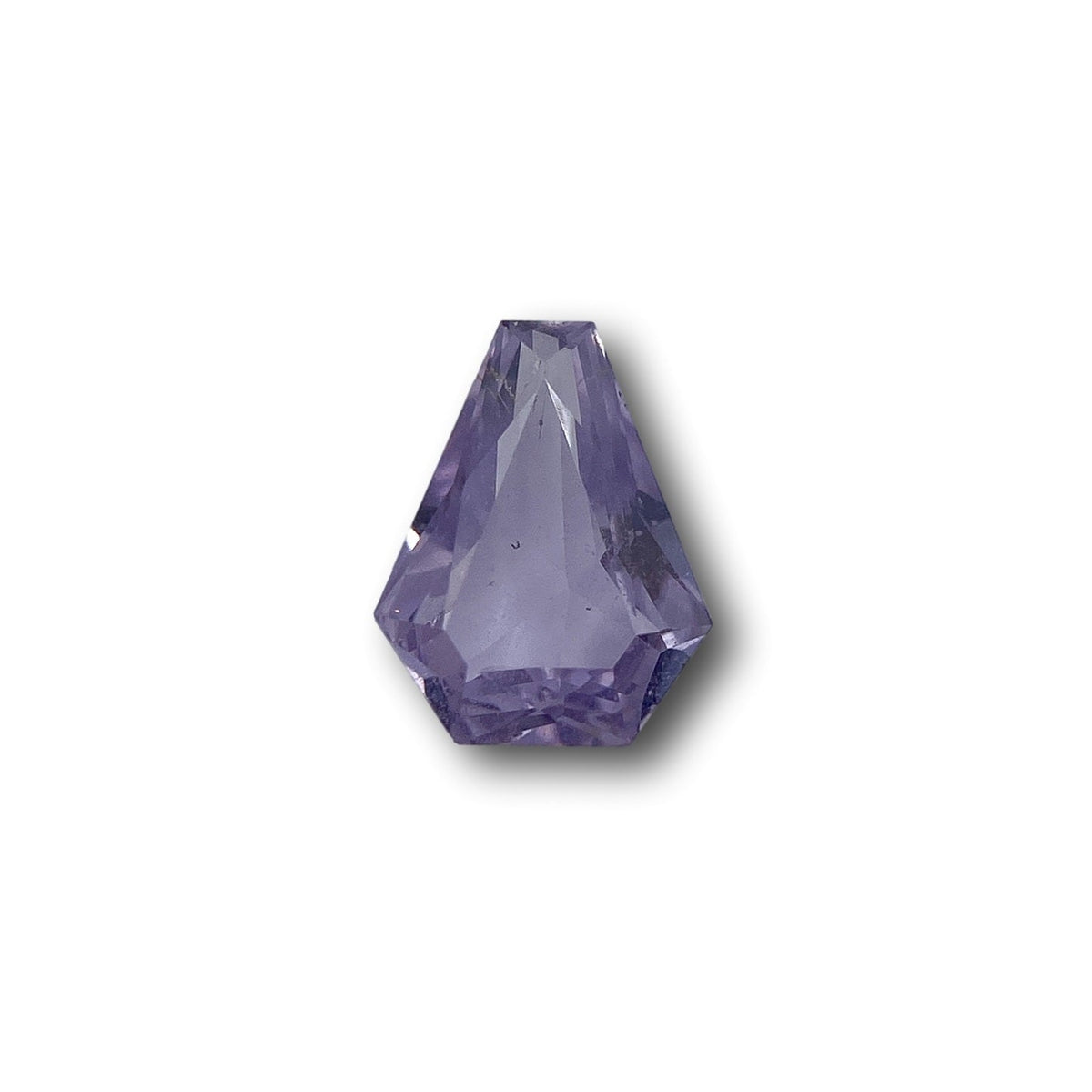 1.03ct brilliant cut shield-shaped pink sapphire gemstone with faceted edges on a white background.