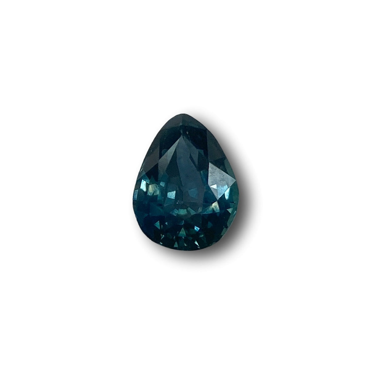 1.05ct pear-shaped blue Montana sapphire with a brilliant cut, isolated on a white background.