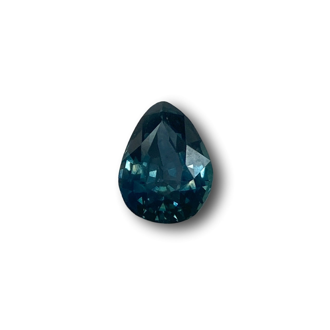 1.05ct pear-shaped blue Montana sapphire with a brilliant cut, isolated on a white background.