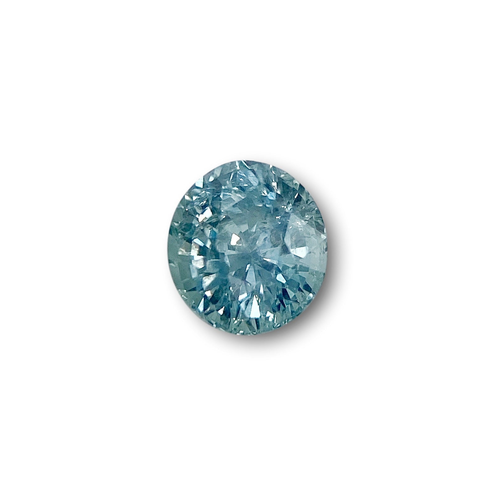 1.07ct oval brilliant cut blue Montana sapphire gemstone with sparkling facets on a white background.