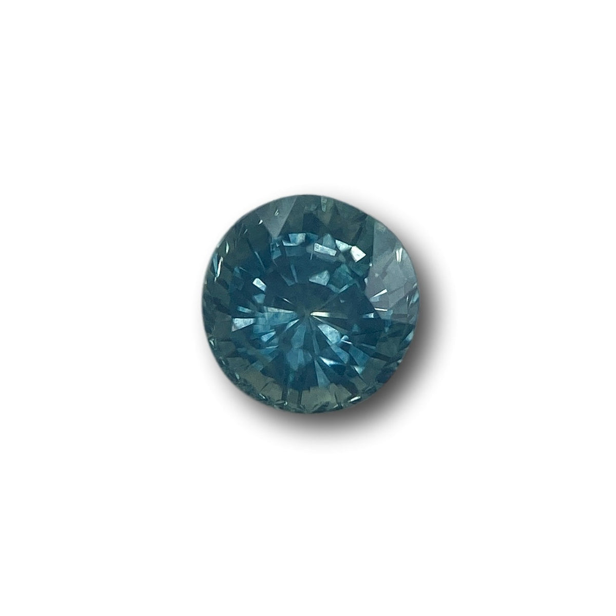 1.07ct round brilliant cut blue Montana sapphire gemstone with faceted surface.