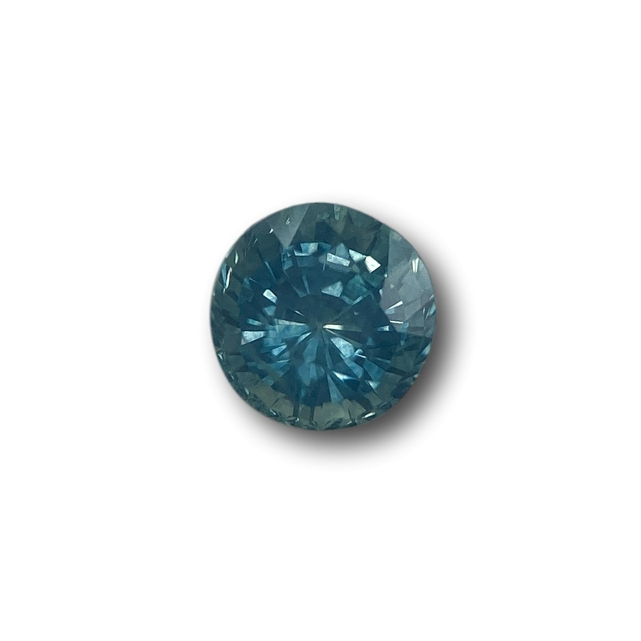 1.07ct round brilliant cut blue Montana sapphire gemstone with faceted surface.