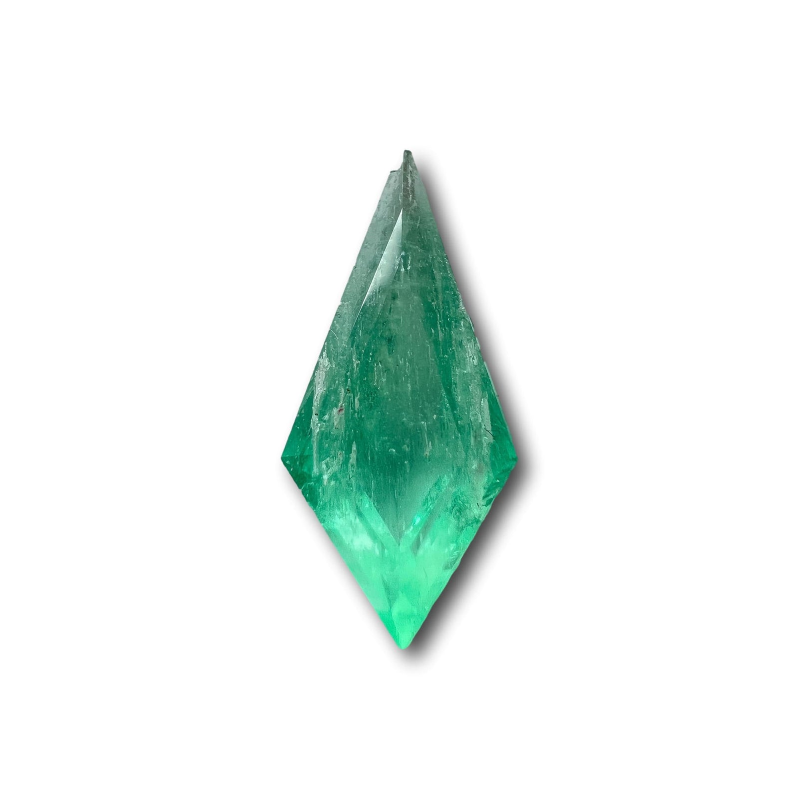 1.08ct kite-shaped Muzo emerald with a step cut and vibrant green color isolated on a white background.