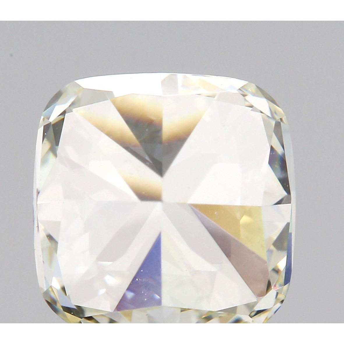1.11ct M color VVS2 clarity cushion brilliant cut natural diamond with high-clarity facets on a neutral background.