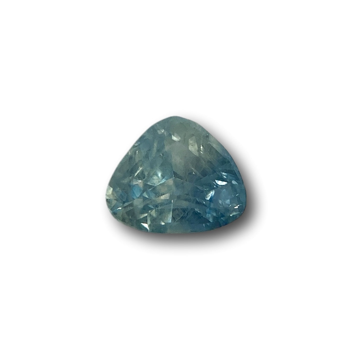 1.16ct pear-shaped blue Montana sapphire with a brilliant cut, showcasing faceted light blue tones on a white background.