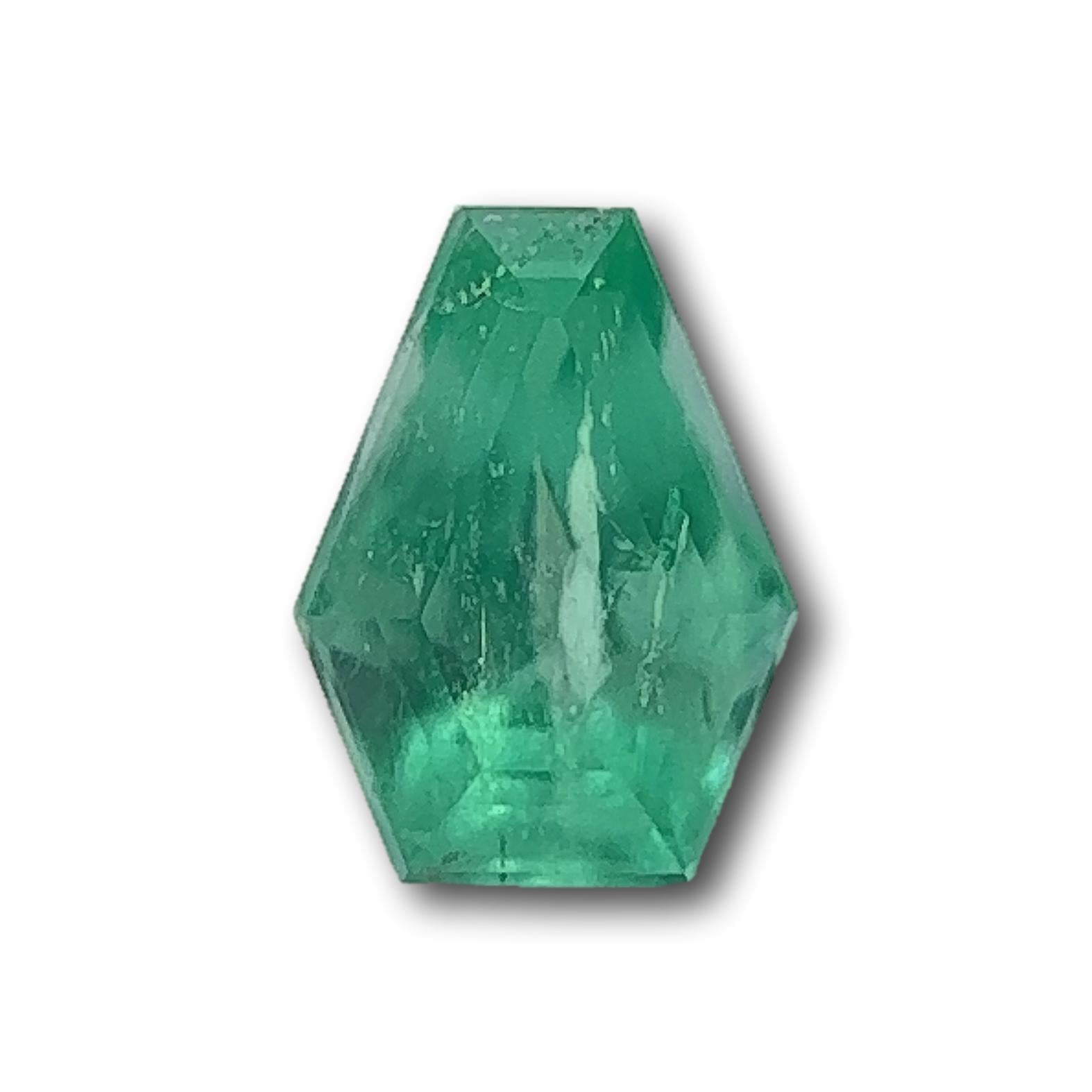 1.16ct Muzo Colombian emerald with a step-cut shield shape and vibrant green color.