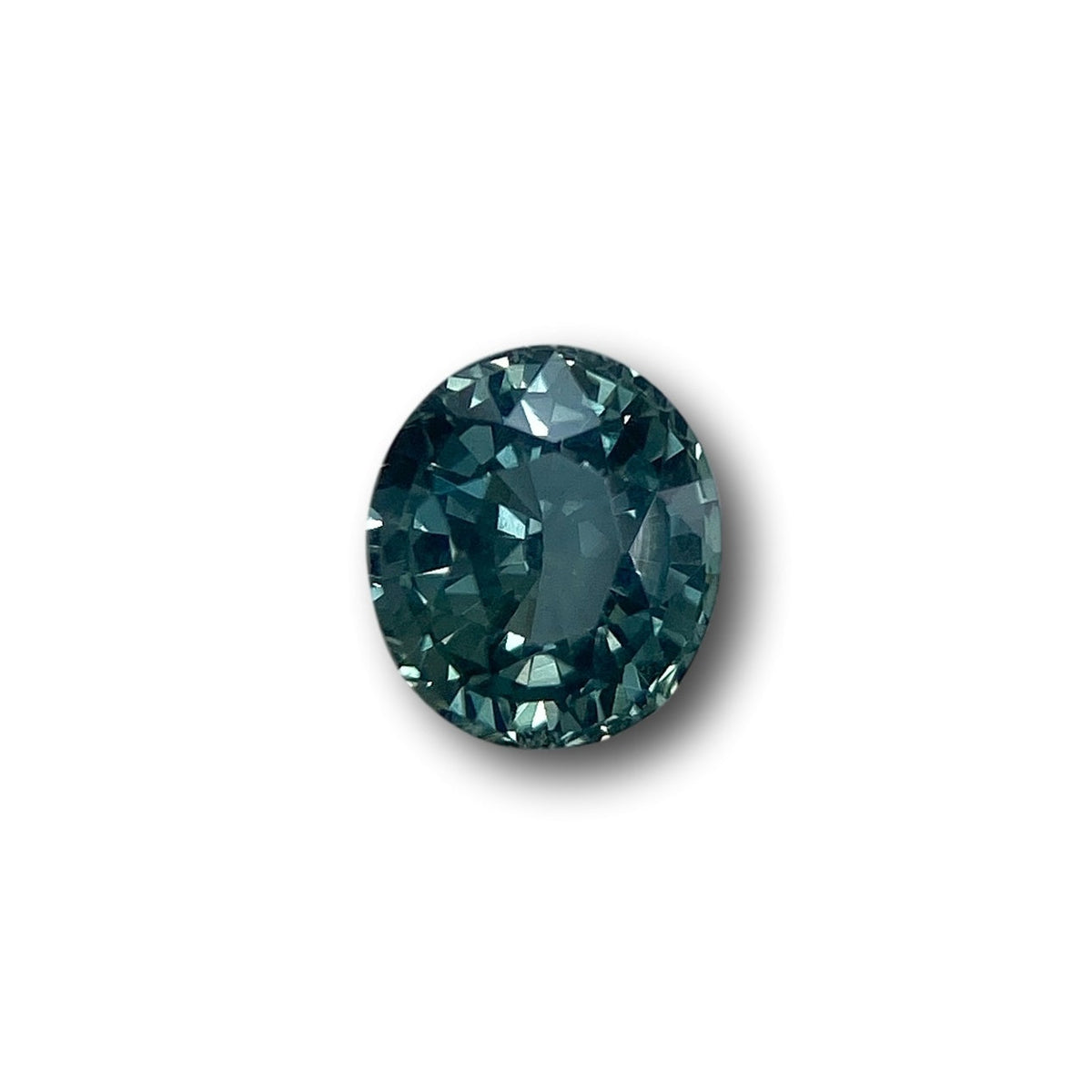 1.17ct oval brilliant cut blue Montana sapphire gemstone with deep teal tones and faceted clarity.