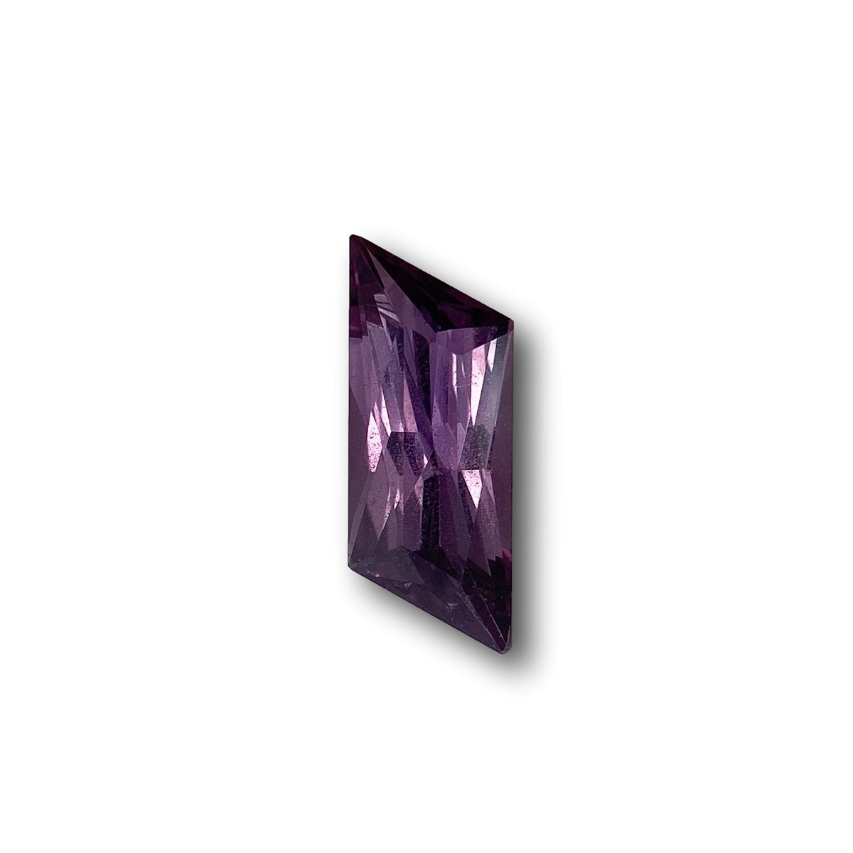 1.18ct brilliant cut violet sapphire in a unique rhomboid shape with faceted surfaces.