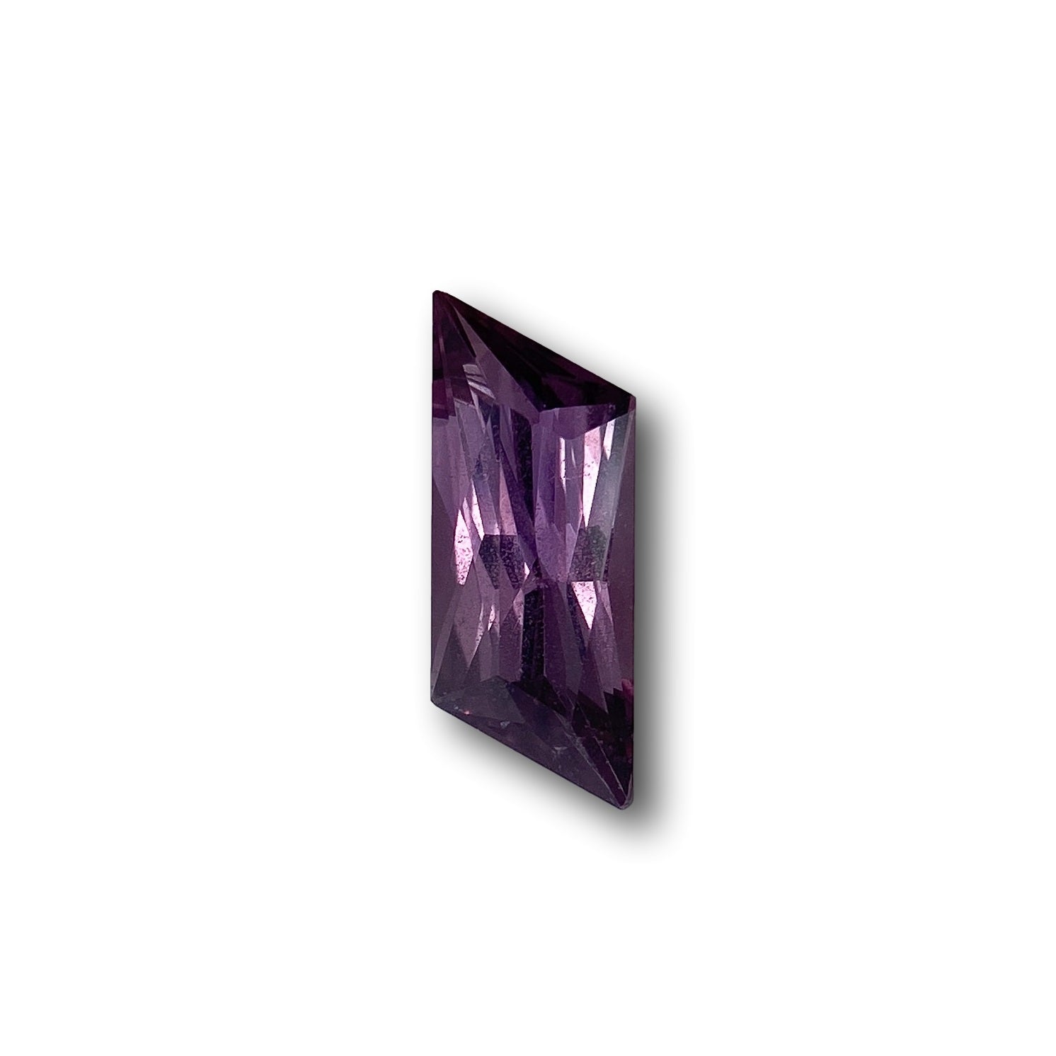1.18ct brilliant cut violet sapphire in a unique rhomboid shape with faceted surfaces.