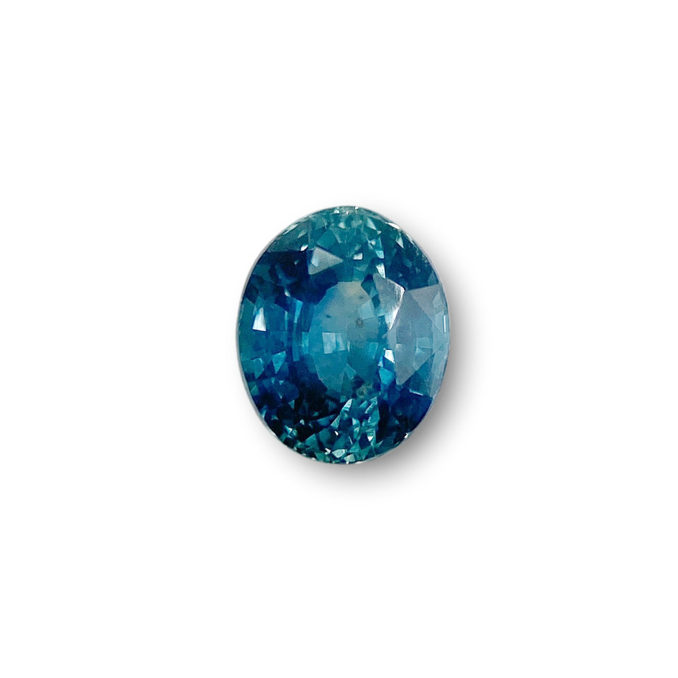 1.27ct oval brilliant cut blue Montana sapphire gemstone with faceted surface.