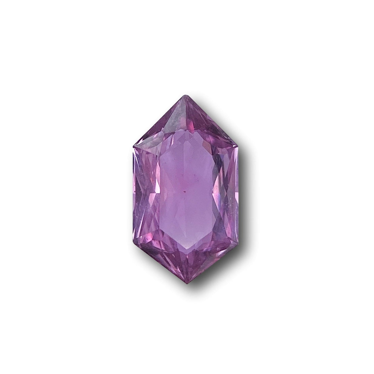 1.31ct brilliant cut violet sapphire in a unique hexagon shape, measuring 9.45 x 5.30mm against a white background.