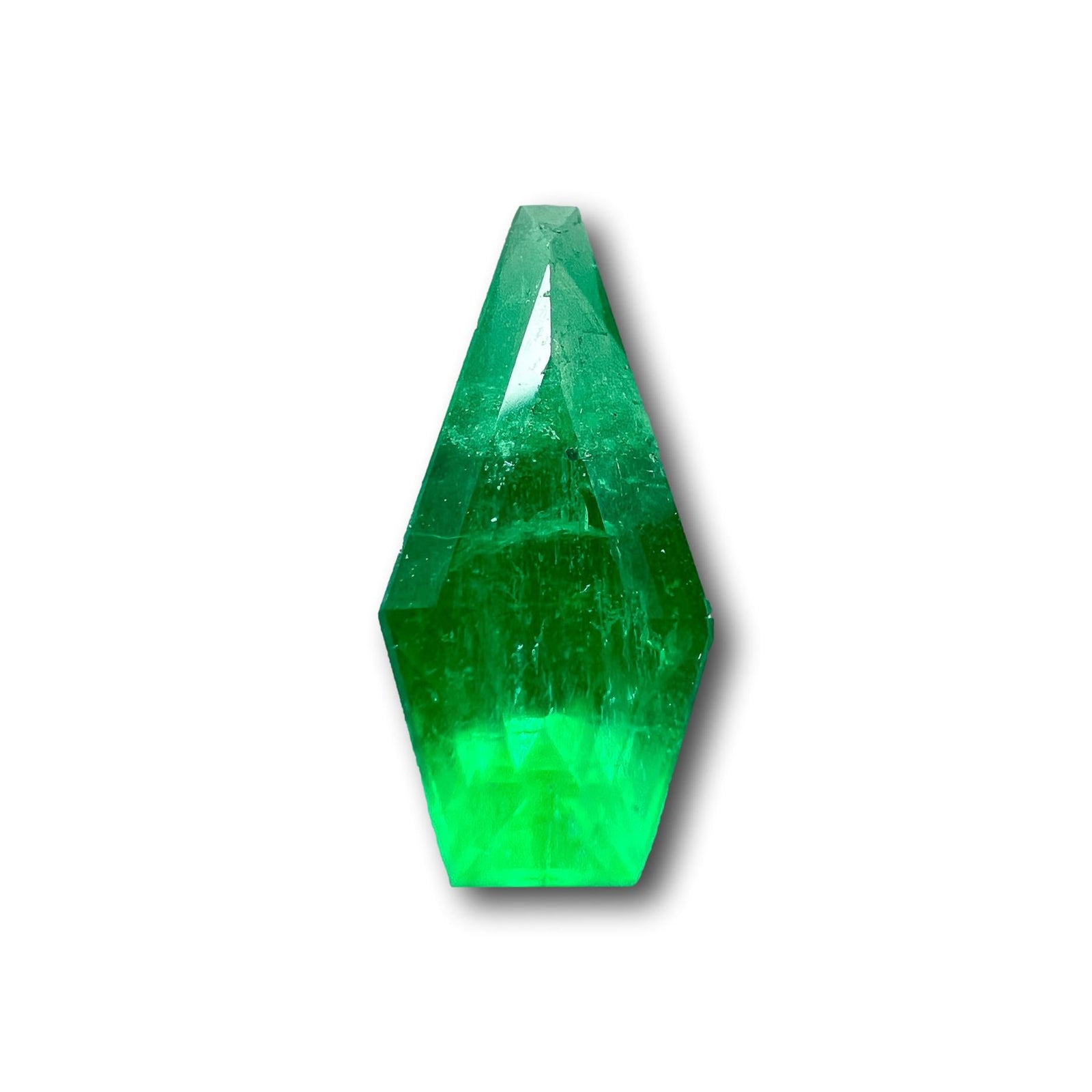 1.33ct Muzo Colombian emerald with a step-cut shield shape and vibrant green color.