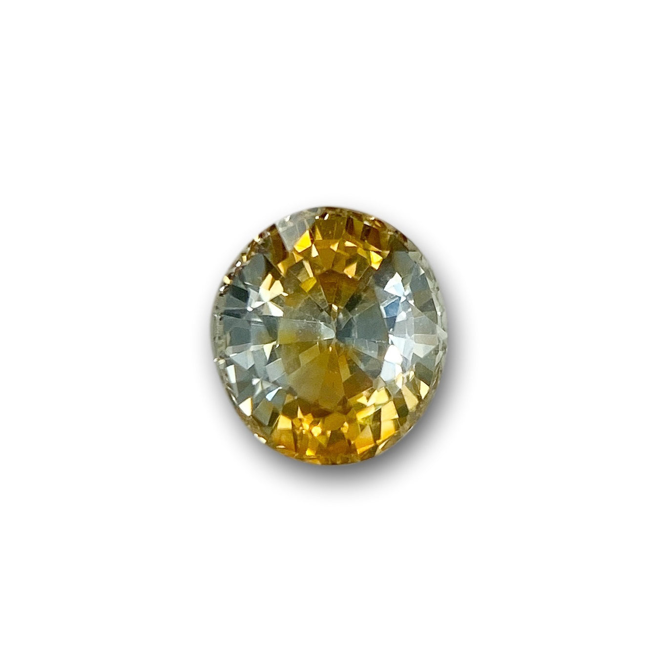 1.42ct oval brilliant cut yellow Montana sapphire with sparkling facets on a white background.