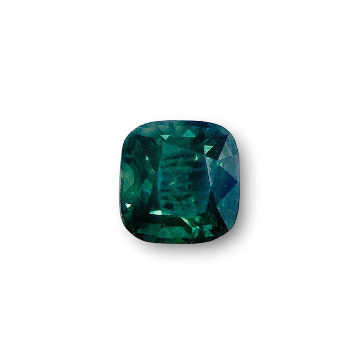 1.46ct cushion-cut green Montana sapphire with a brilliant facet pattern on a white background.