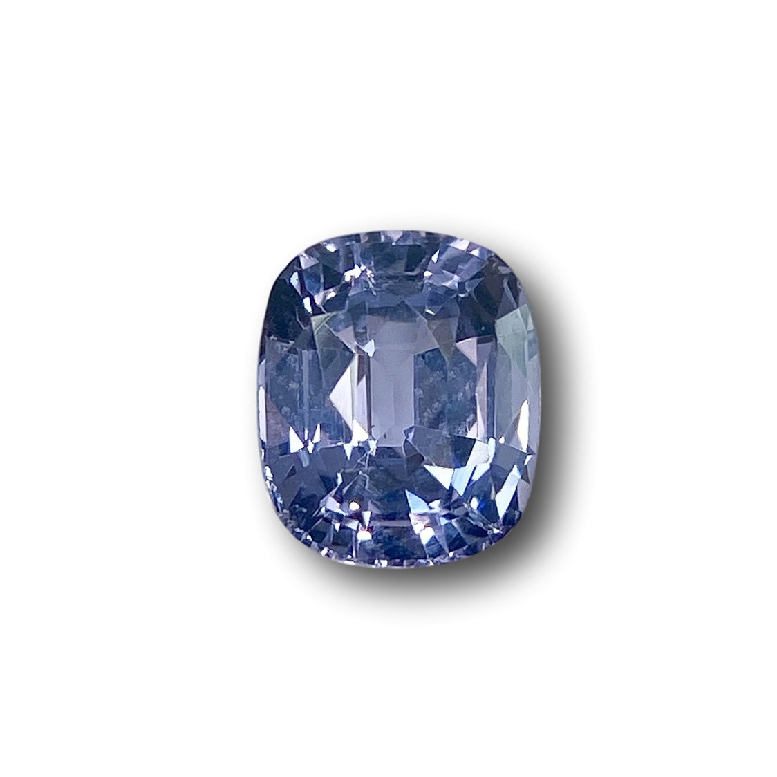 1.64ct cushion-cut blue spinel gemstone with a brilliant faceted surface against a white background.