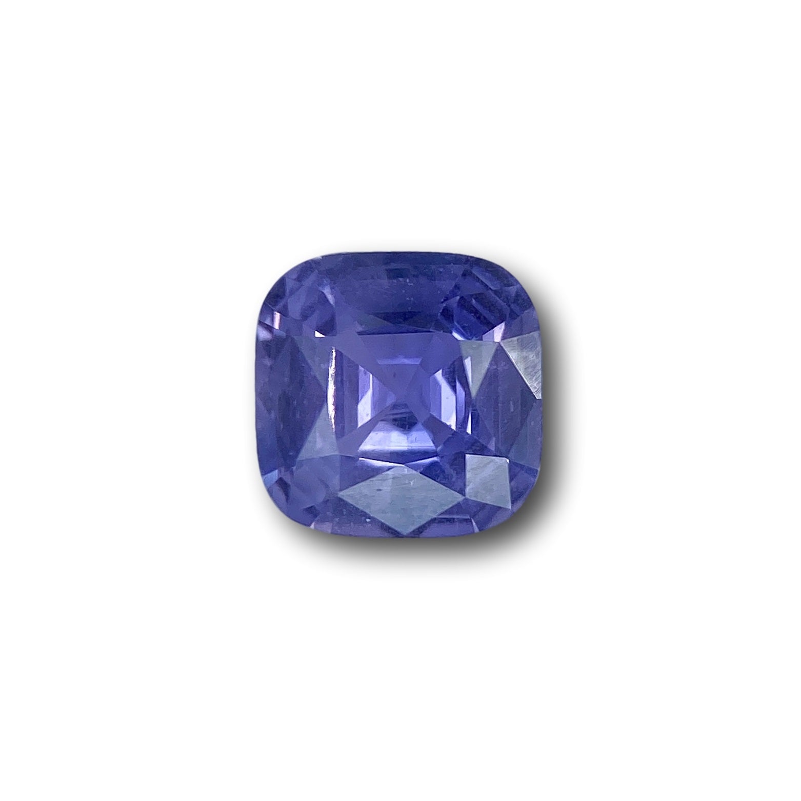 1.80ct cushion-cut blue sapphire with a brilliant facet pattern, measuring 7.30 x 7.25 mm against a white background.
