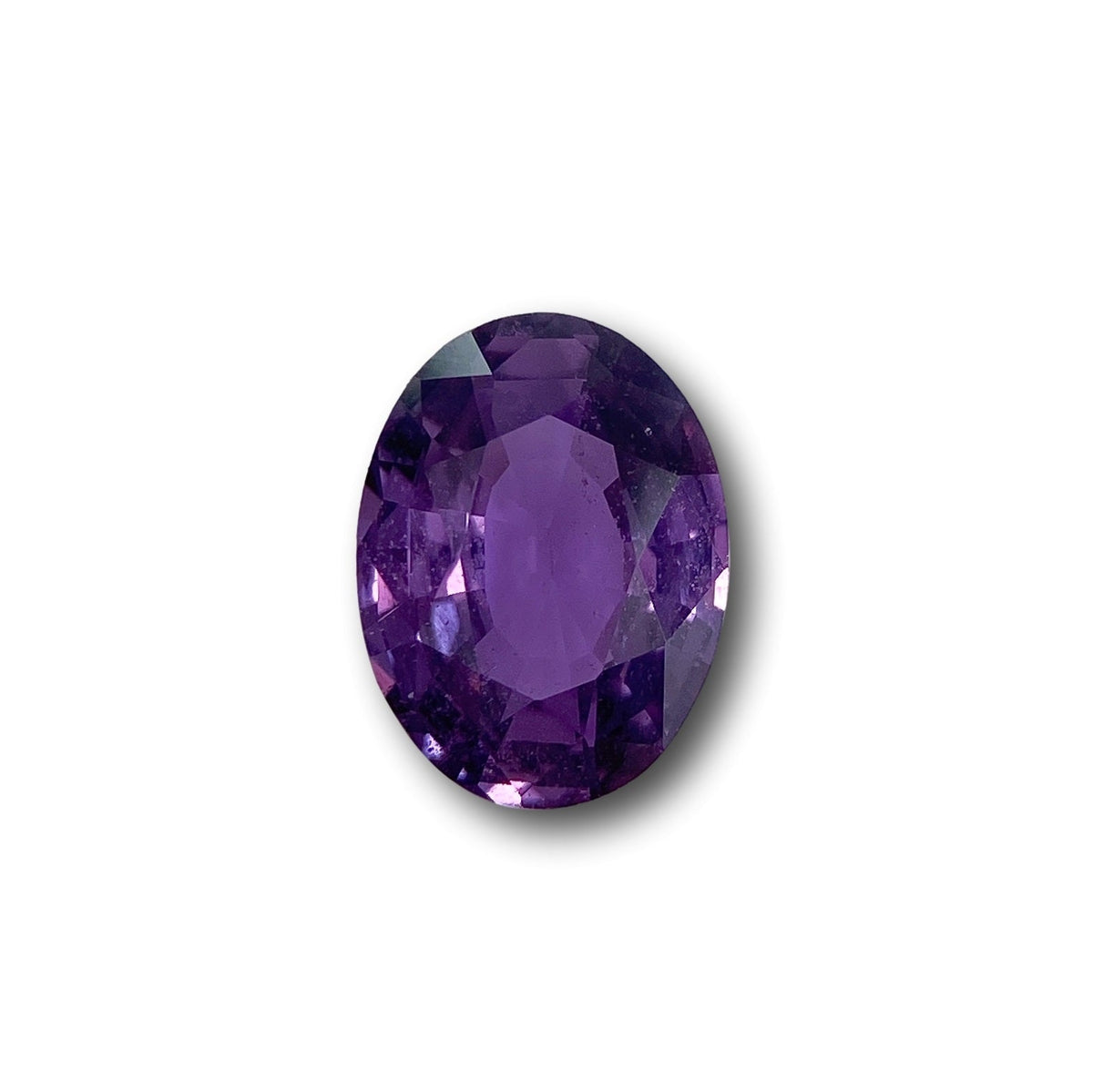 2.02ct oval brilliant cut pinkish-purple sapphire gemstone isolated on white background.