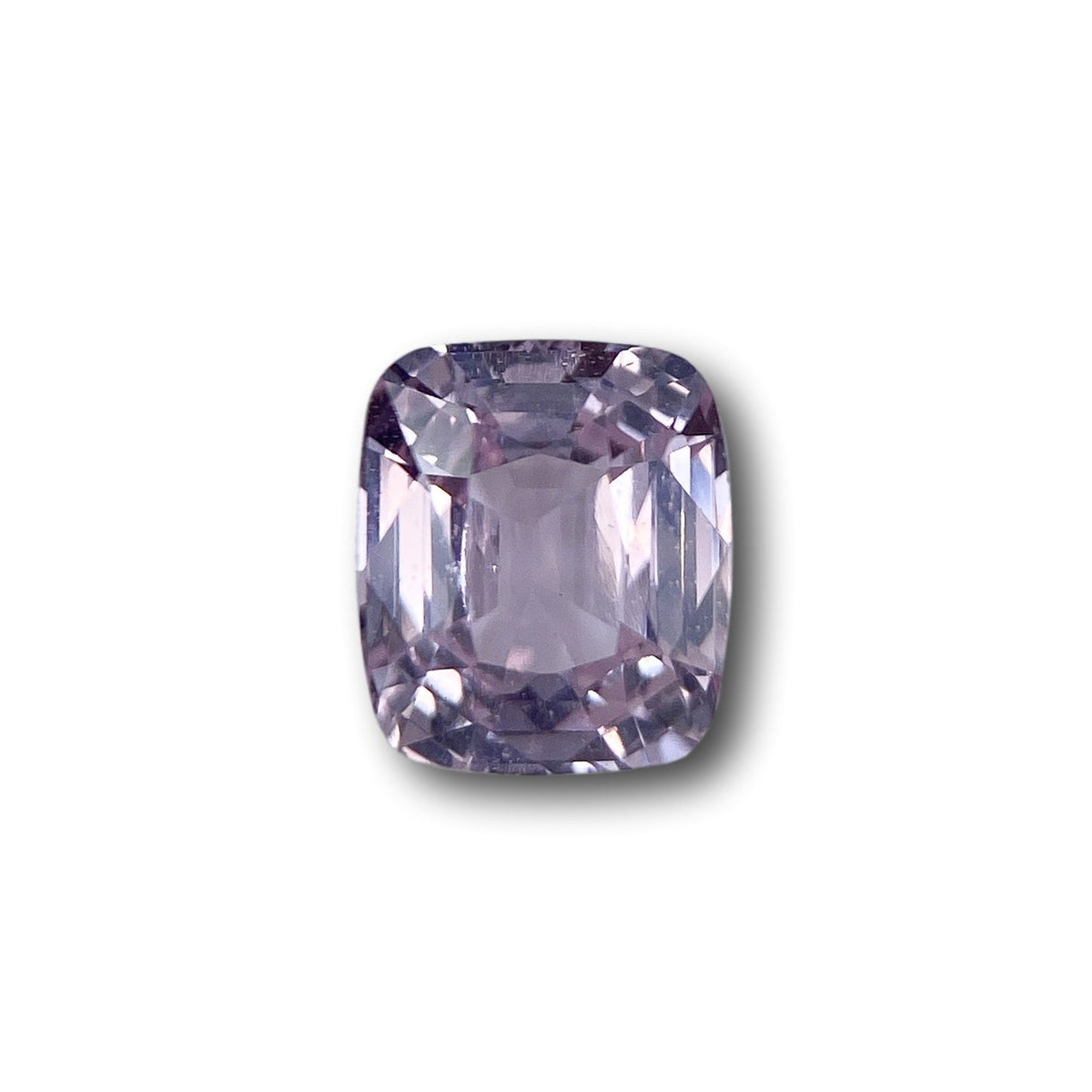 2.04ct brilliant cut cushion-shaped pink sapphire gemstone with faceted edges on a white background.