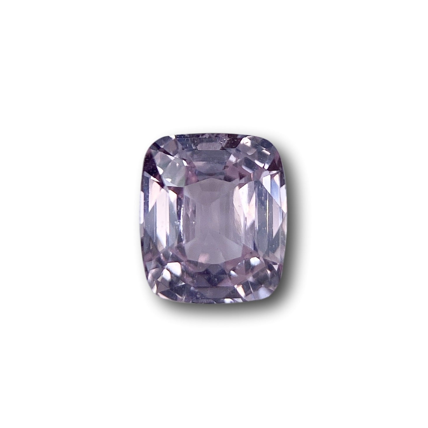 2.04ct brilliant cut cushion-shaped pink sapphire gemstone with faceted edges on a white background.