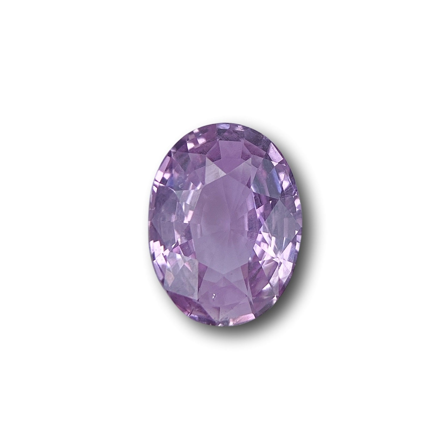 2.06ct oval brilliant cut pink sapphire gemstone with a faceted surface and light purple hue.