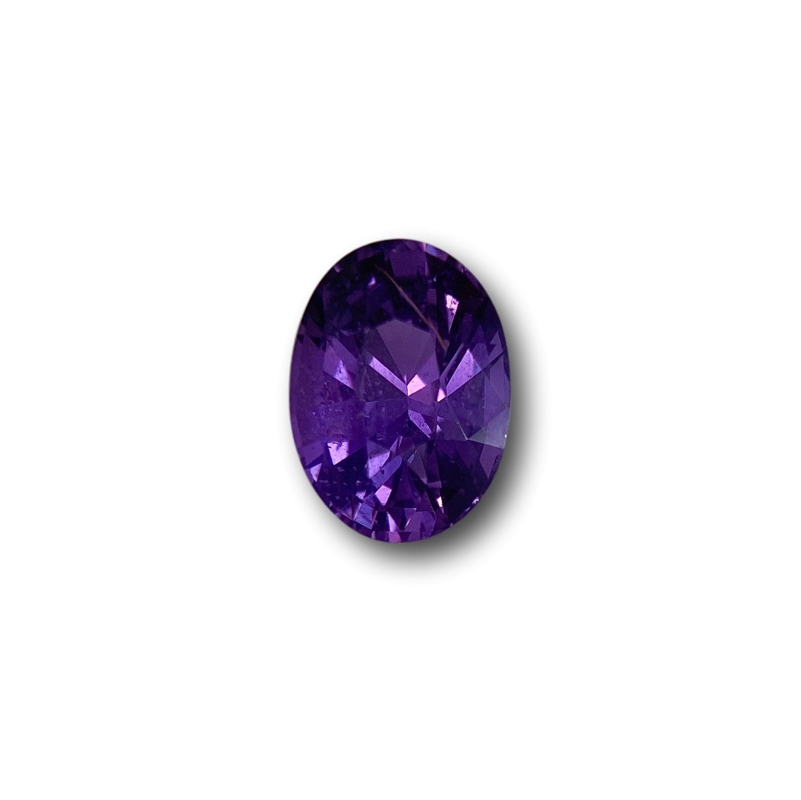 2.07ct oval brilliant cut violet sapphire gemstone with deep purple facets and a polished finish.