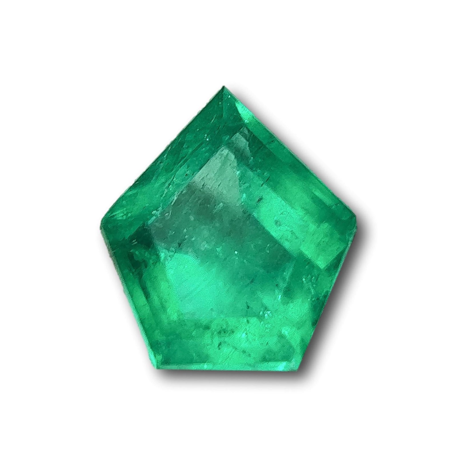 2.21ct Muzo emerald with a step-cut shield shape and vibrant green color isolated on a white background.