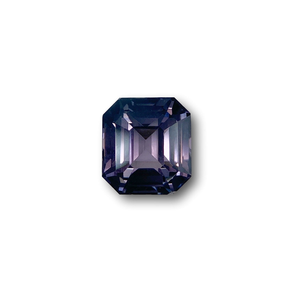 2.63ct emerald-cut blue-purple spinel gemstone with step-cut facets on a white background.