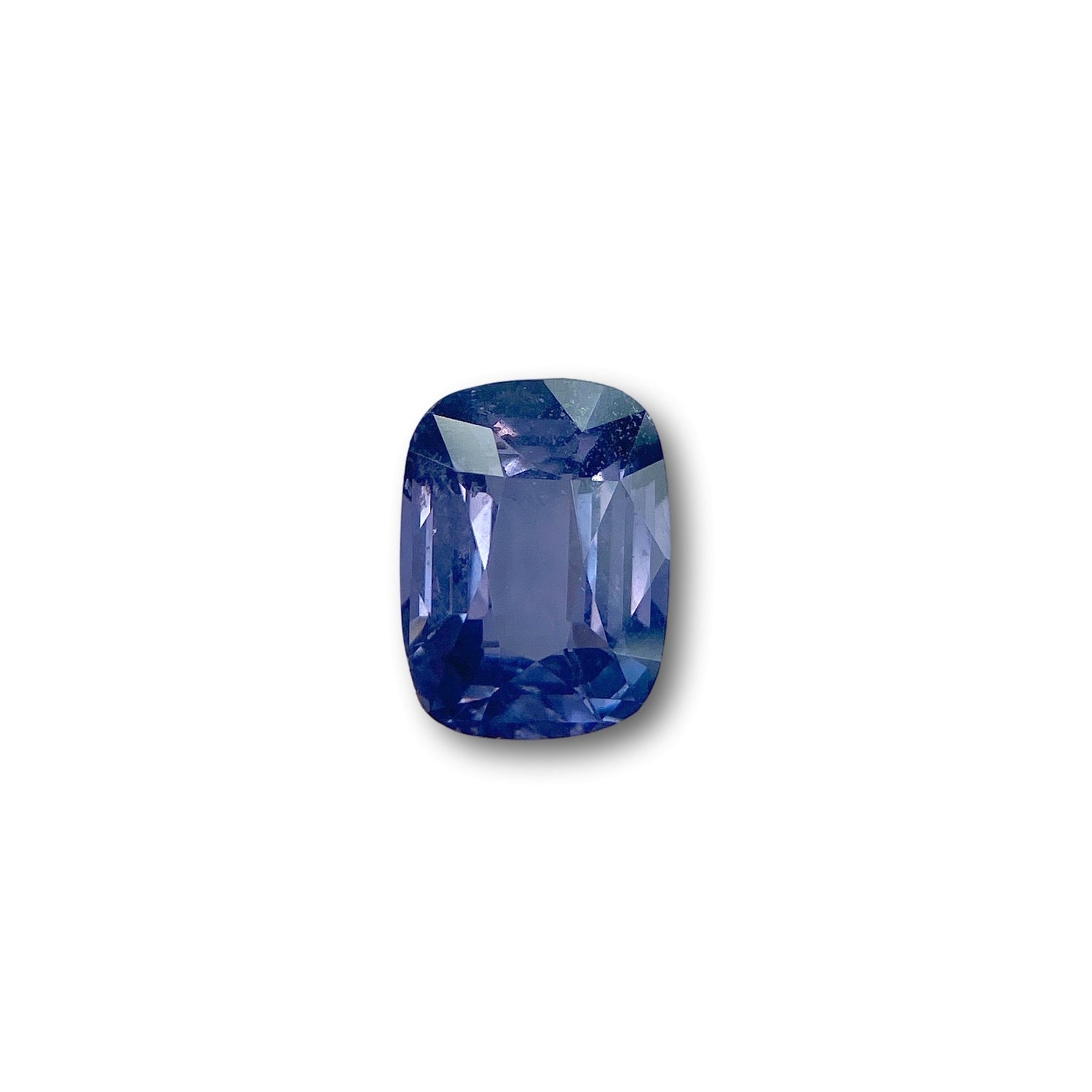 3.07ct cushion-cut blue spinel gemstone with a brilliant facet pattern isolated on a white background.