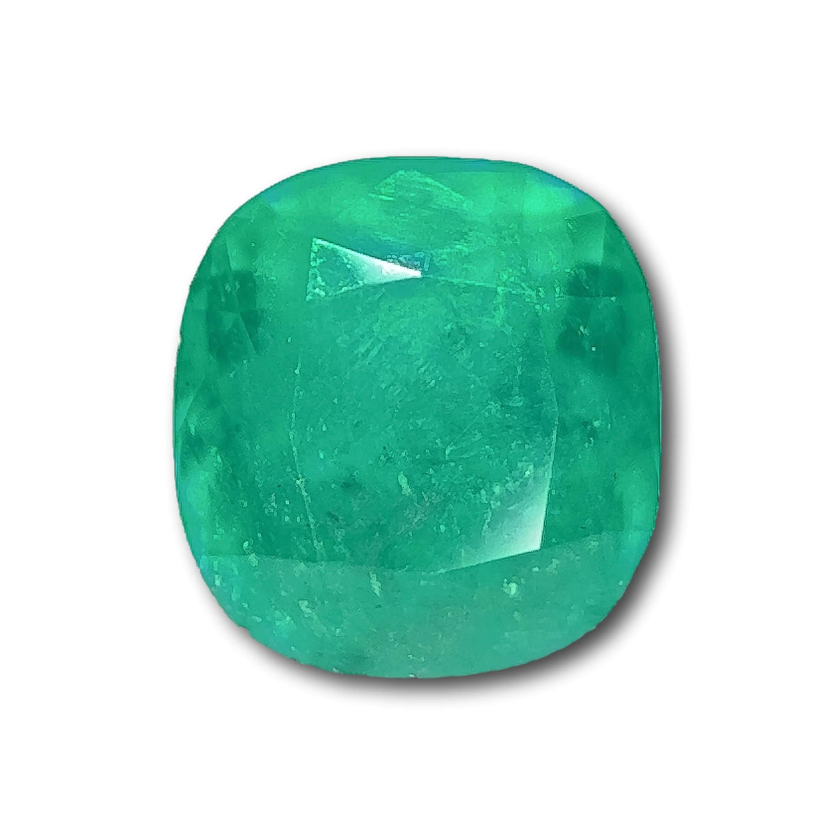 3.10ct brilliant cut cushion-shaped Muzo emerald with a vibrant green hue and faceted surface.