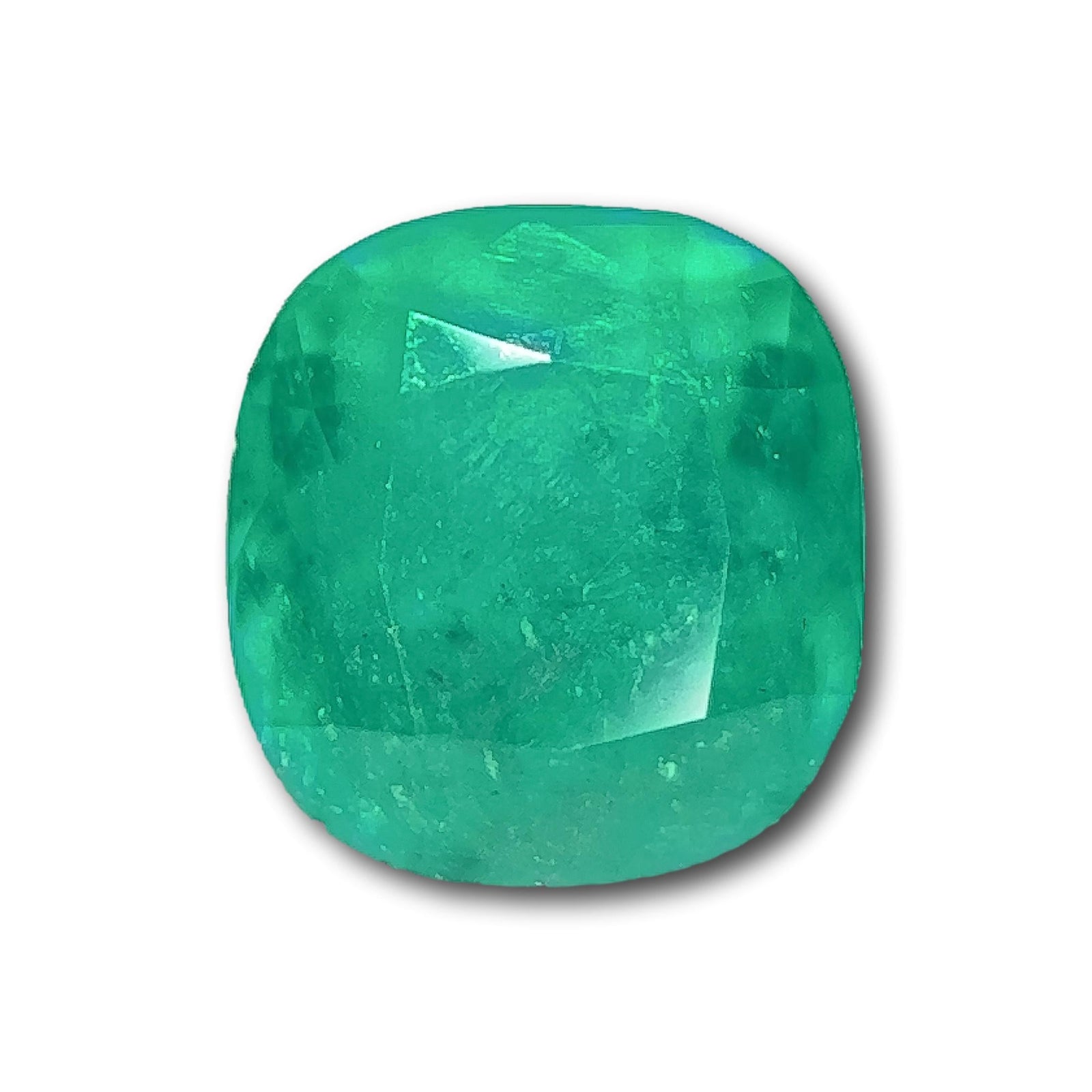 3.10ct brilliant cut cushion-shaped Muzo emerald with a vibrant green hue and faceted surface.