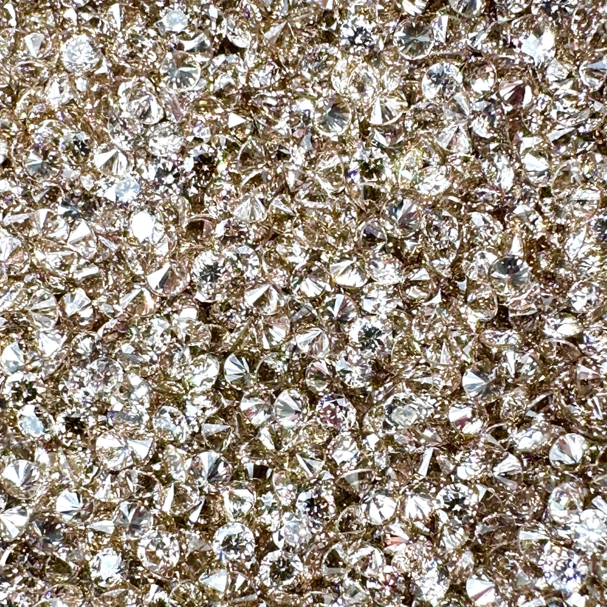Sparkling round brilliant champagne diamond melee stones with high luster and natural warm brown tones.