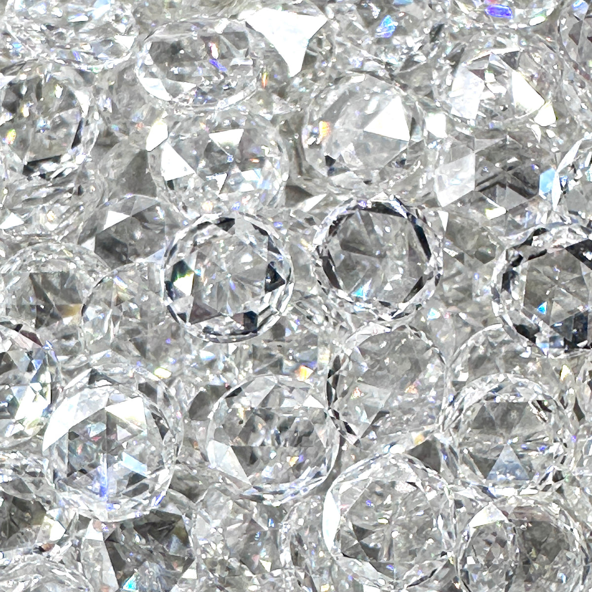 Collection of sparkling white rose cut diamond melee stones with faceted surfaces and G/H color clarity.